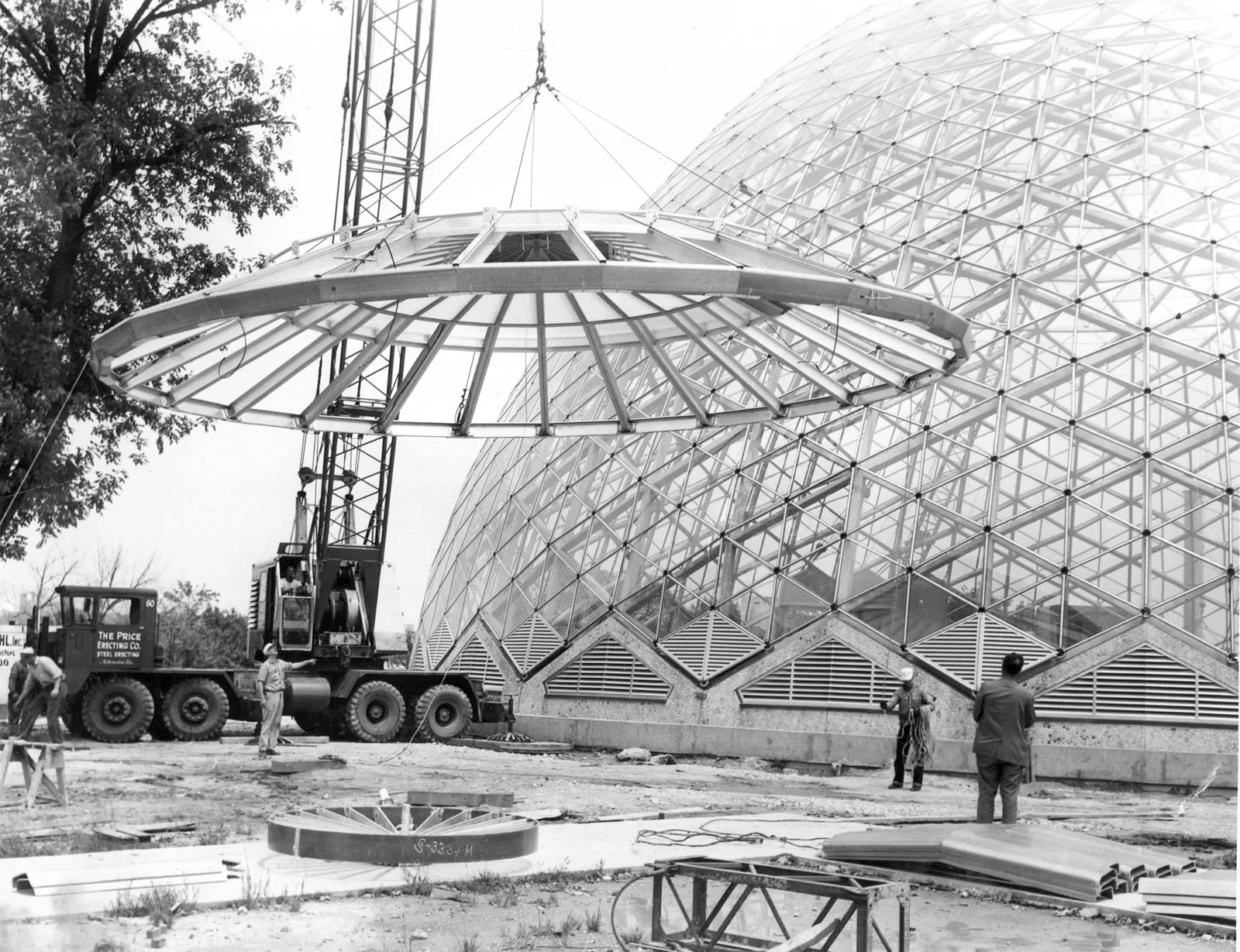 a crane lifts the lid of the Dome into place during construction in the 1960s